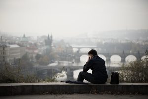 Man sitting on edge of building